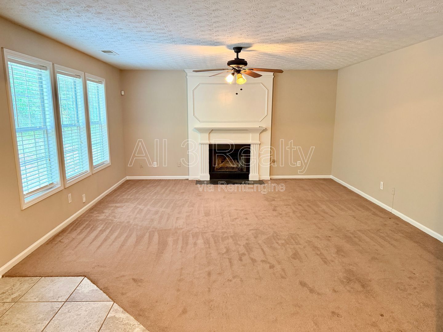 Charming 3-bedroom, 2.5-bath home in Lithonia, GA featuring a cozy fireplace and ceiling fans throughout. property image